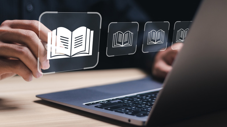 Значки книги плавают поверх MacBook