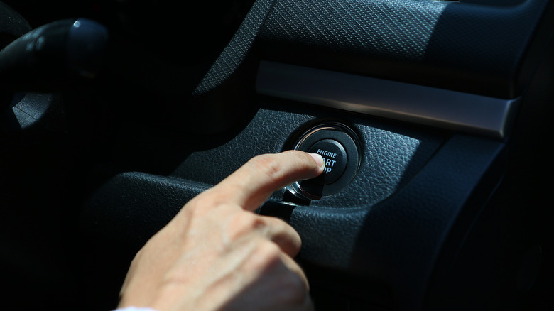 Человек, запускающий машину с кнопки