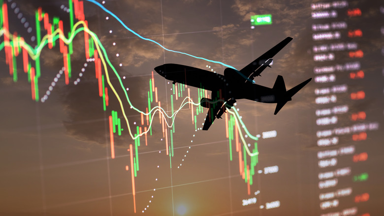 Силуэт пассажирского самолета на фоне статистического графика.