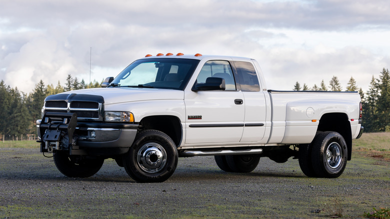 Белый Dodge Ram 3500 HD с двойными задними колесами, передним видом 3/4, белой внешностью, расширенной кабиной