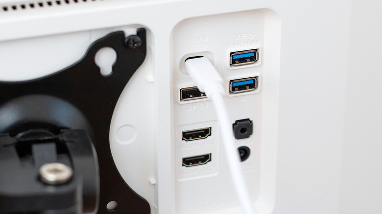 Порты на белом мониторе с кабелем USB-C подключены.