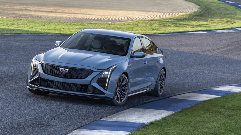 Вид крупным планом серого Cadillac CT5-V Blackwing на трассе, вид спереди в 3/4.