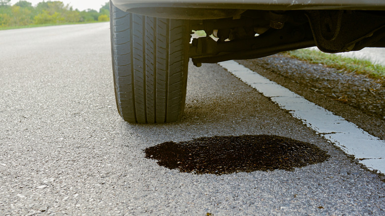 Течь масла из автомобиля, припаркованного у дороги