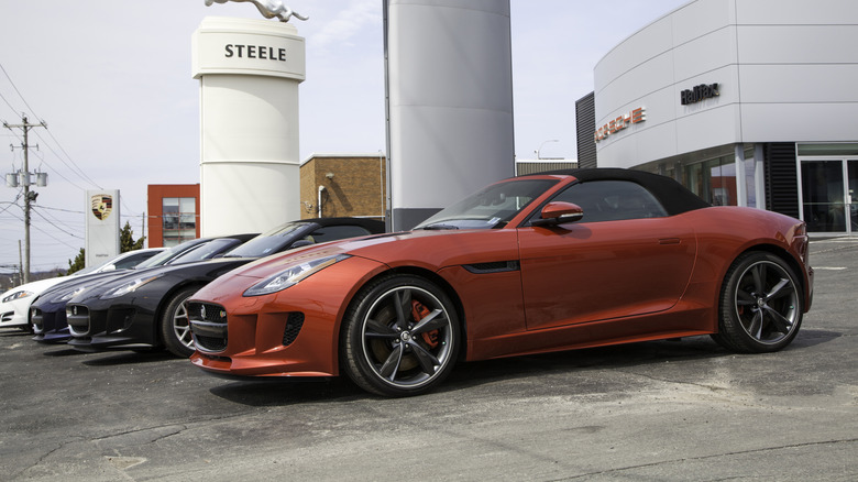 Ряд Jaguar F-Type 2014 года выпуска, припаркованный у автосалона