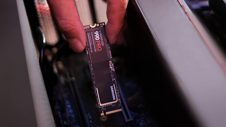 SSD-накопитель Samsung 990 Pro рядом с материнской платой компьютера.