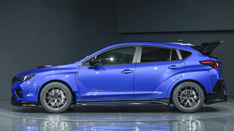 Вид сбоку синего концепта Subaru Performance-B STI 2025 года, припаркованного в студии.
