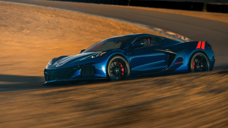 Синий и красный C8 Chevy Corvette Grand Sport проезжает поворот на гоночной трассе.