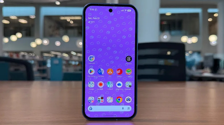 Google Pixel 10a стоит вертикально на столе