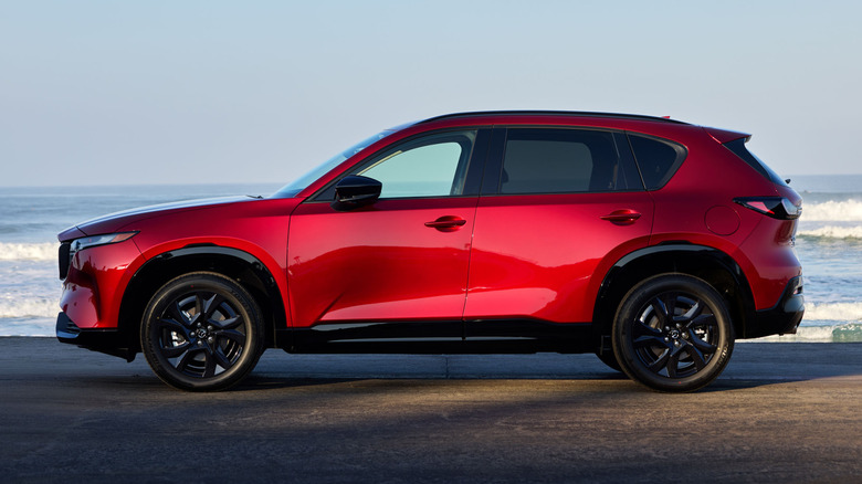 Красная Mazda C-5 припаркована на пляже