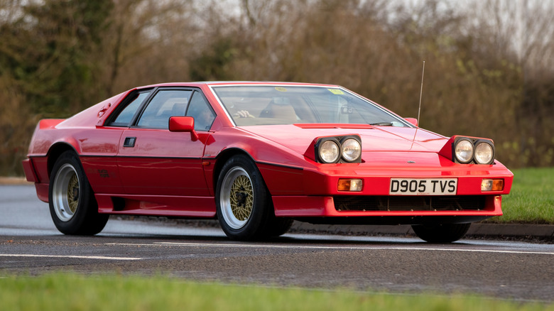 Красный Lotus Esprit Turbo SE едет по дороге.