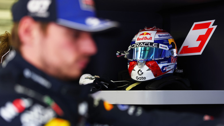 Гоночный шлем Red Bull Formula 1 с Максом Ферстаппеном не в фокусе на переднем плане