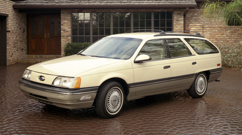 Фургон Ford Taurus 1986 года, припаркованный перед домом, вид спереди слева в 3/4